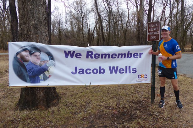 Mike Sohaskey paying his respects to Jacob Wells, founder of 3 Bridges Marathon